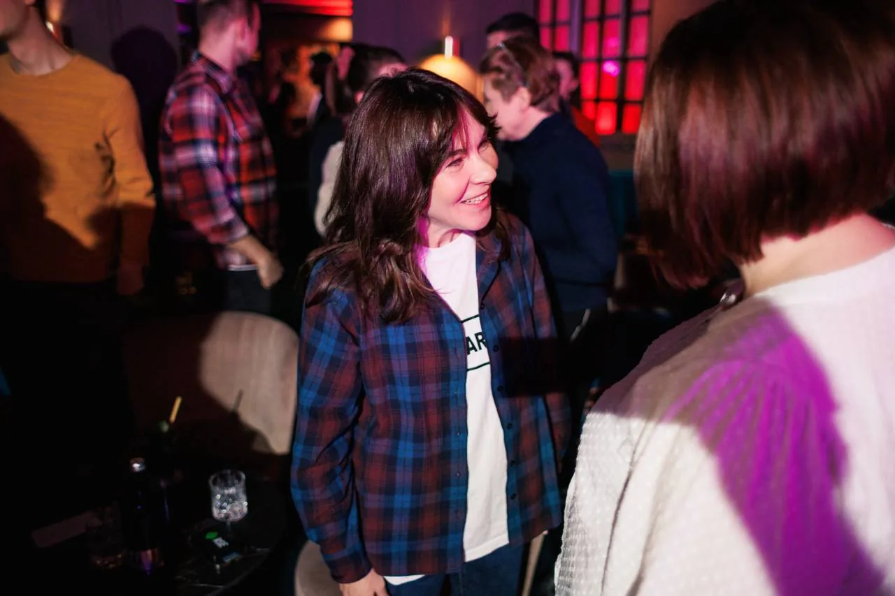 Two attendees laughing mid-conversation at a Playing Talking event